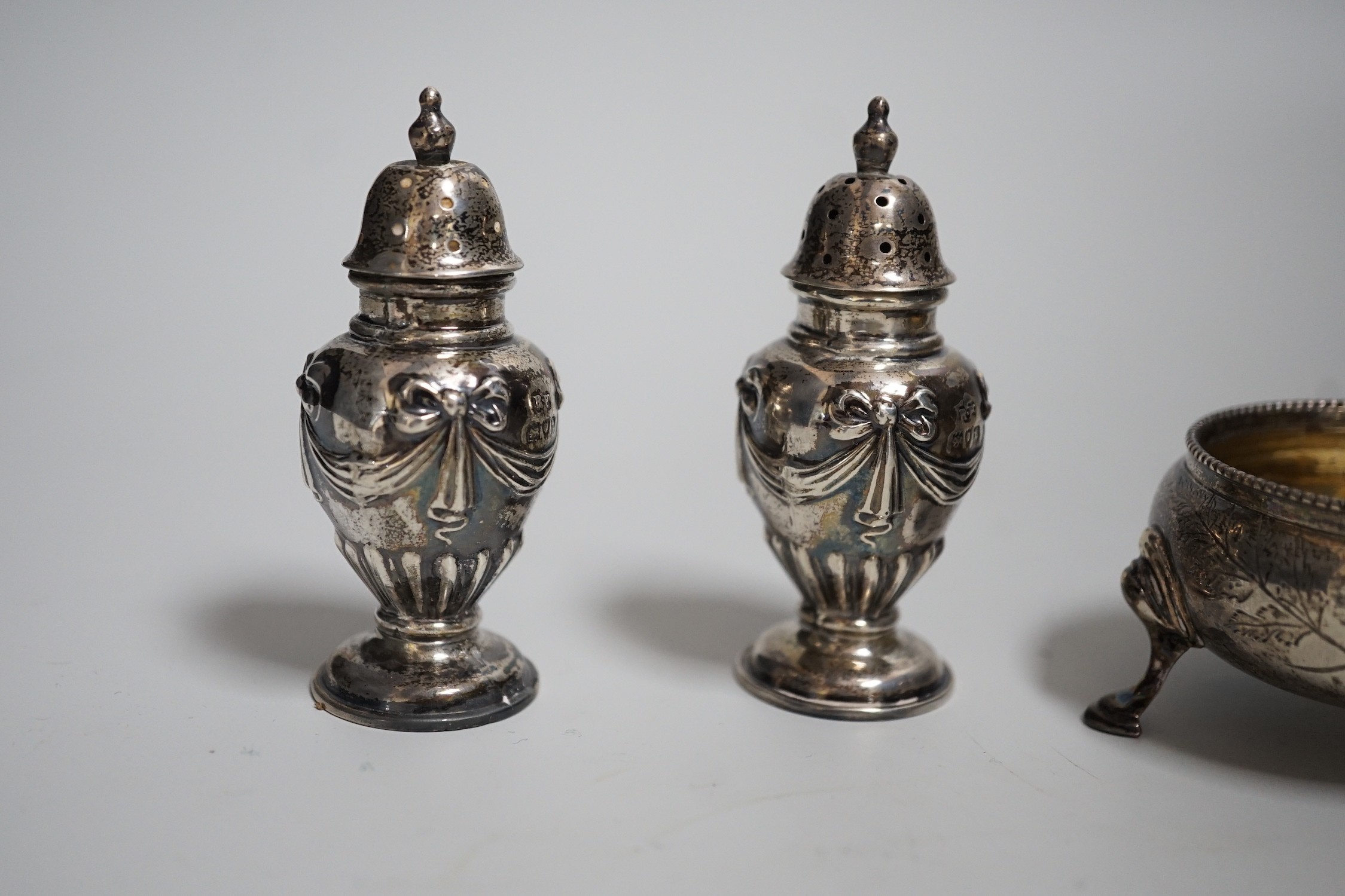 A pair of Victorian silver bun salts, London, 1868, diameter 5cm and a pair of Victorian silver peppers.